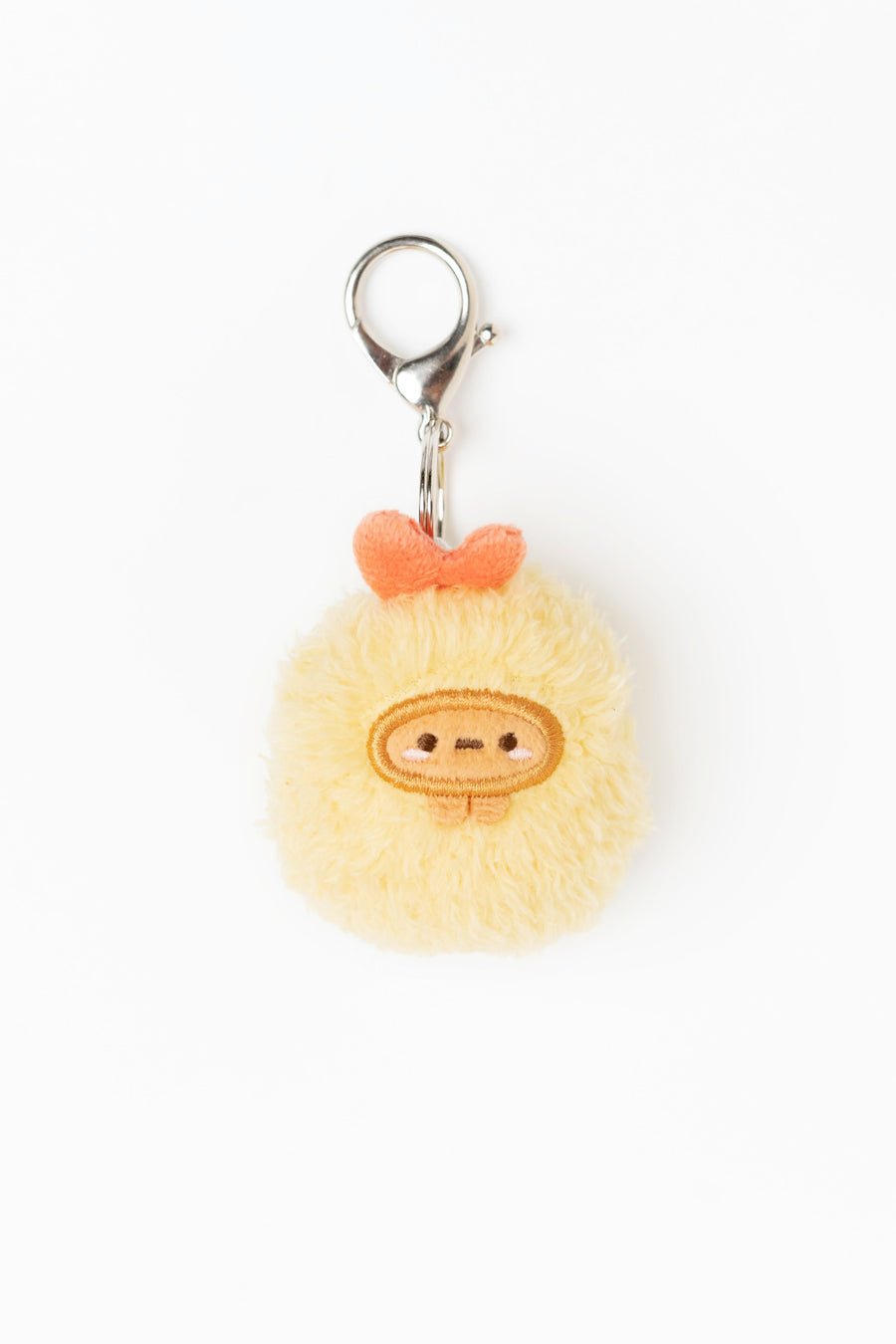 Pom-pom keychain with a face design on a white background