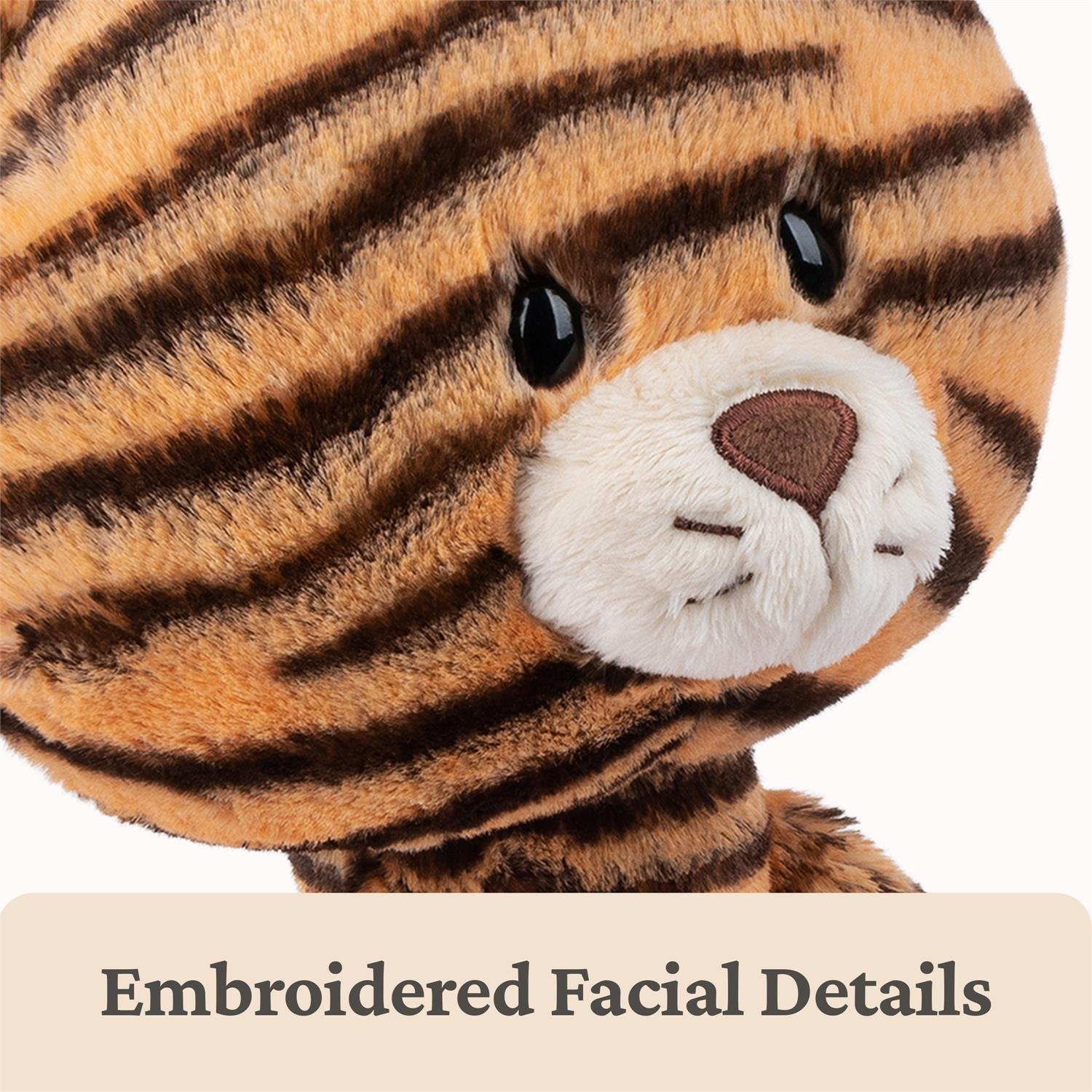 Plush tiger toy with embroidered facial details on a white background