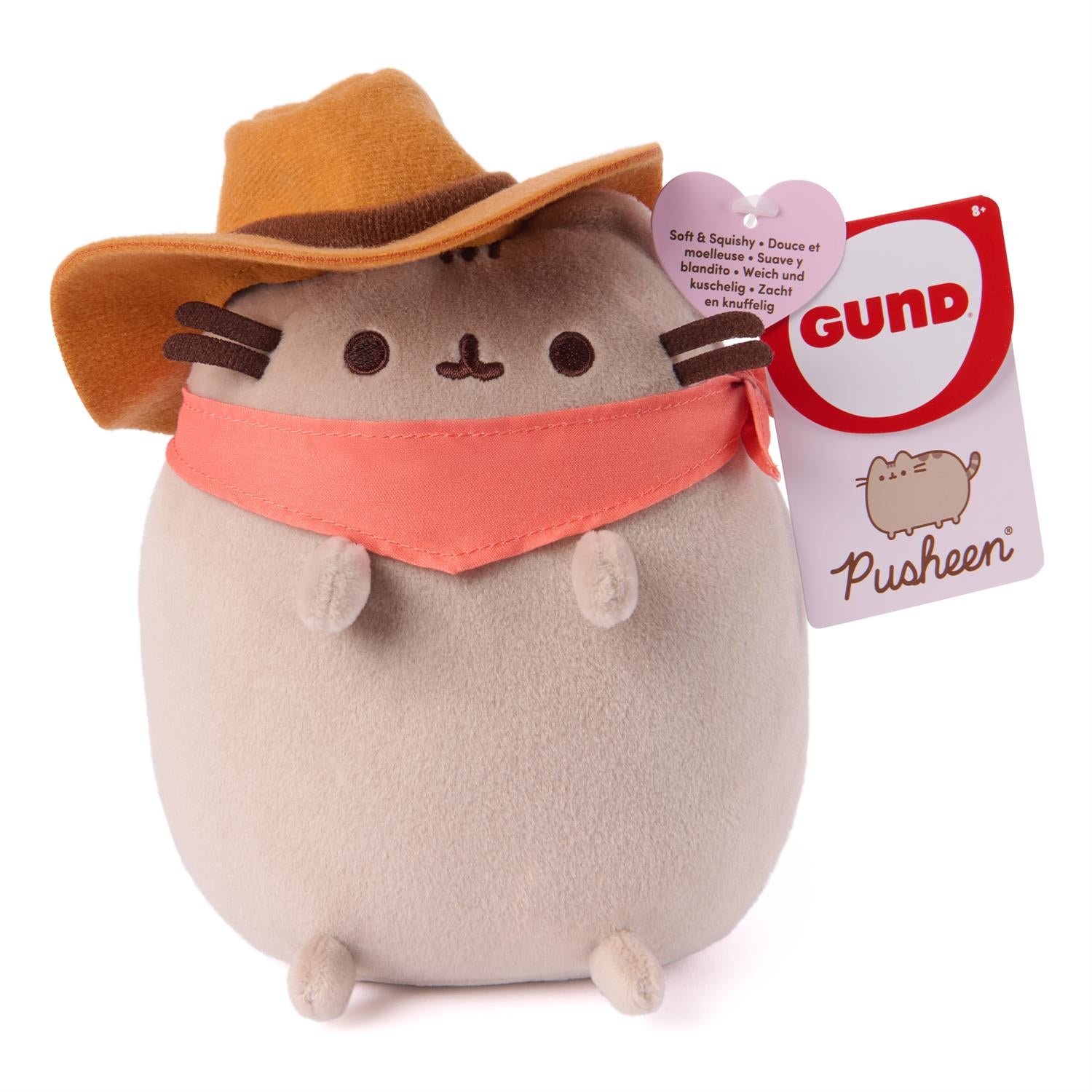 Plush toy resembling a cat in a cowboy hat and bandana with a GUND tag on a white background