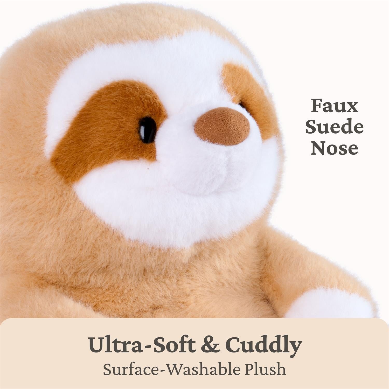 A close-up of a plush sloth toy with tan faux fur, a white face and chest, and brown eye patches. Text on the image reads 'Faux Suede Nose' and 'Ultra-Soft & Cuddly Surface-Washable Plush.