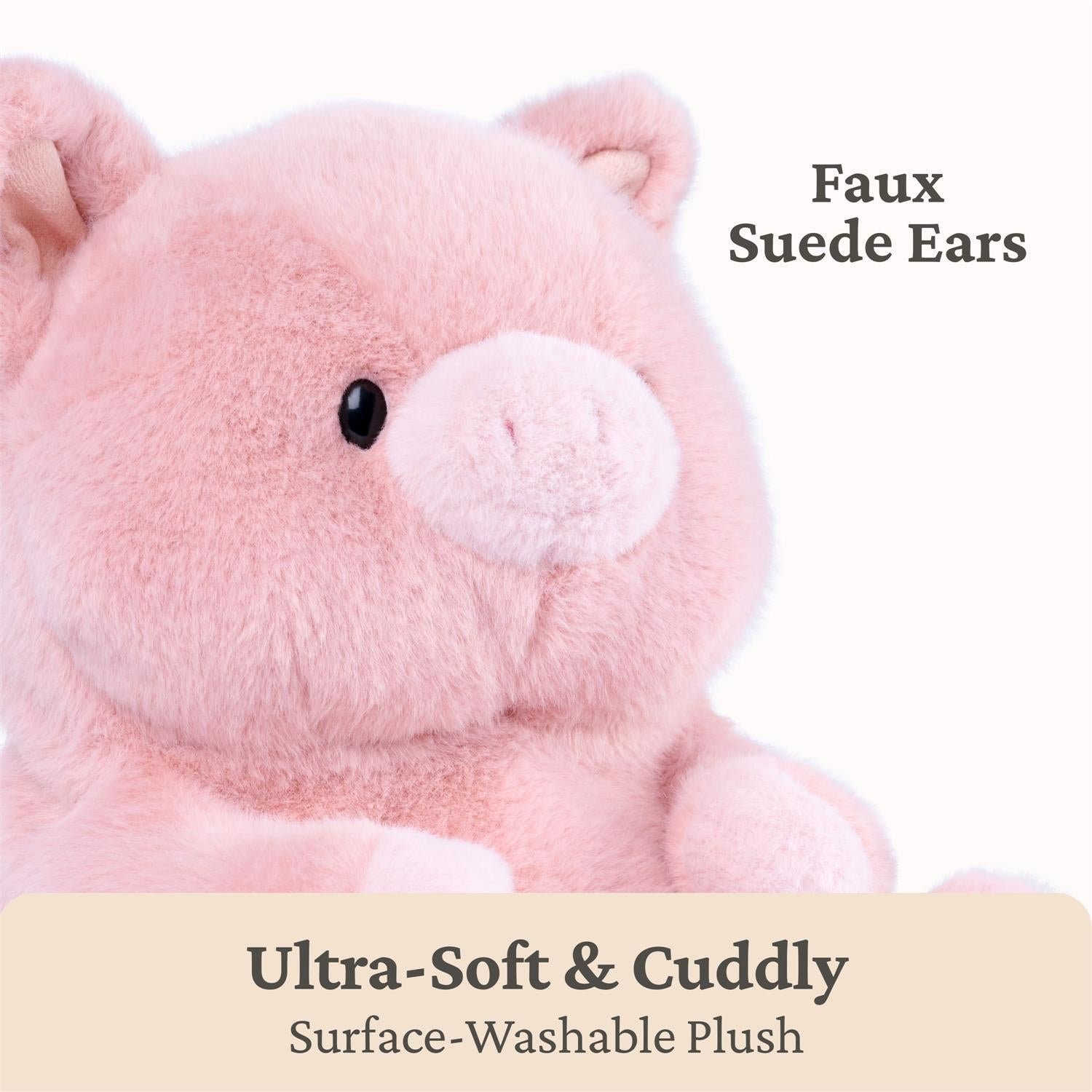 A close-up of a pink plush toy with soft faux suede ears and a black bead eye, on a white background with text reading 'Faux Suede Ears' and 'Ultra-Soft & Cuddly Surface-Washable Plush'.