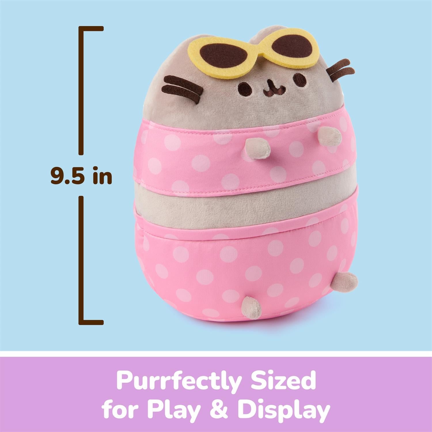 A Pusheen plush toy styled like a round container, wearing pink polka-dot pants and yellow sunglasses, shown on a light blue background with a measurement marker indicating 9.5 in height and a purple banner reading 'Purrfectly Sized for Play & Display'.