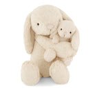 Stuffed bunnies, creamy-white plush.